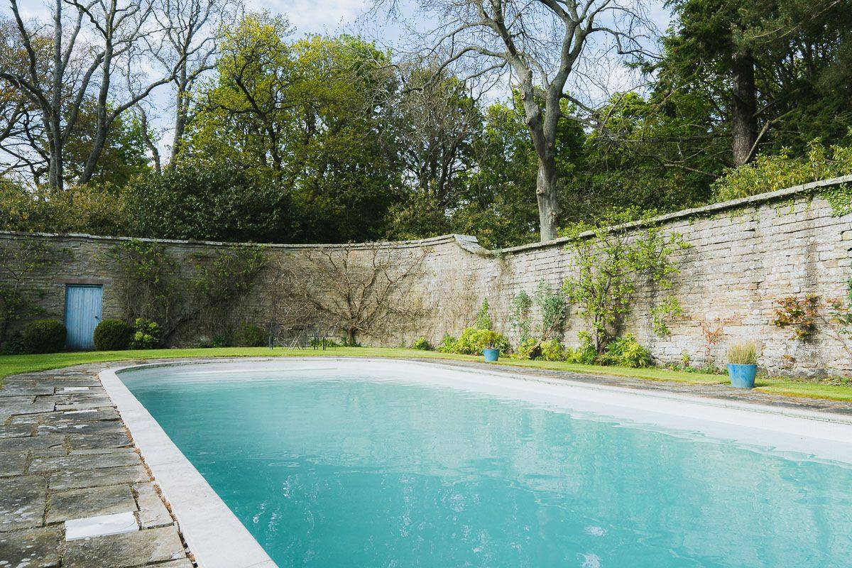 The heated outdoor pool at Birkhill Castle, set within the walled garden