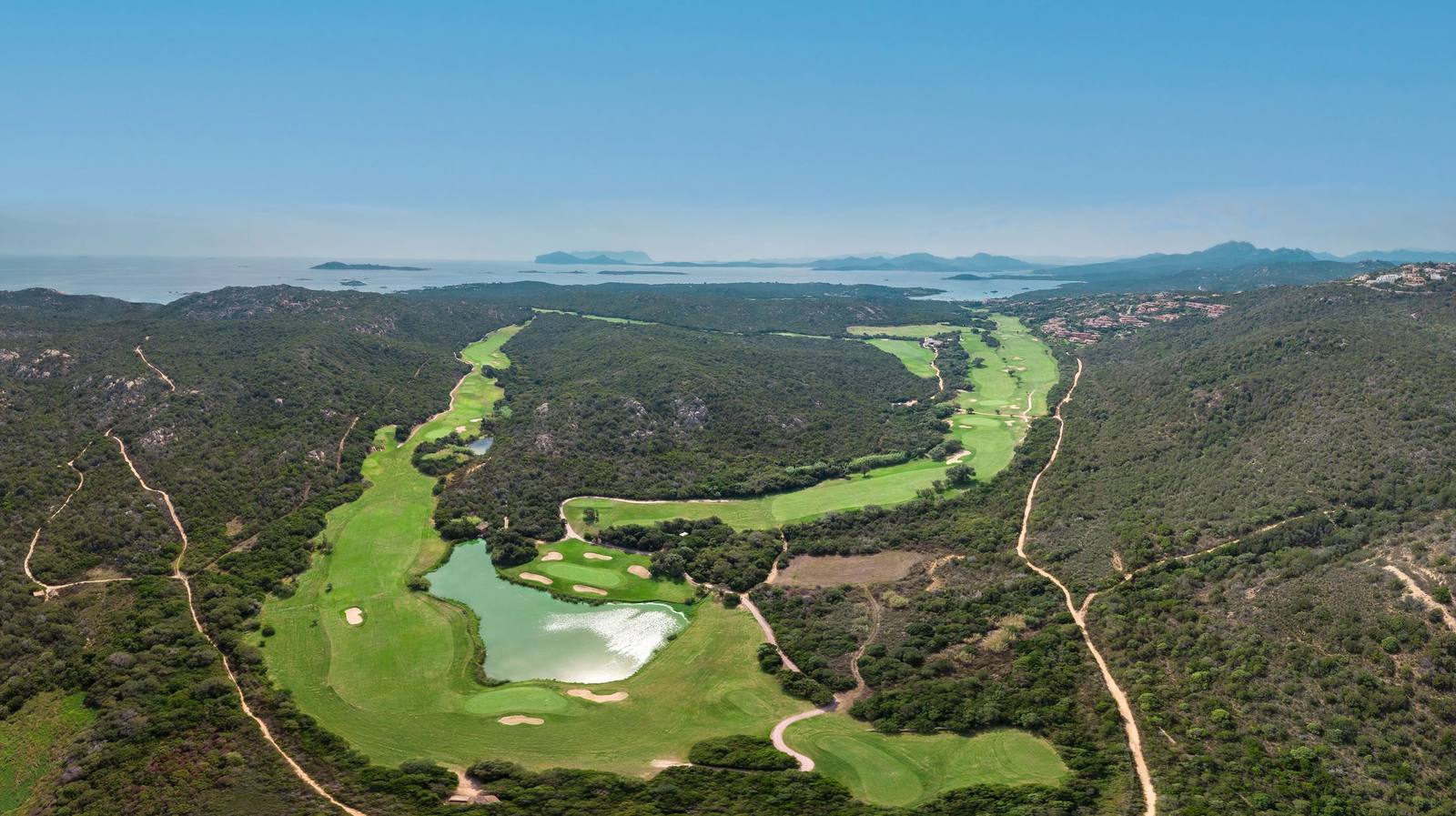 Aerial view of the Pevero Golf Club fairways running towards the sea