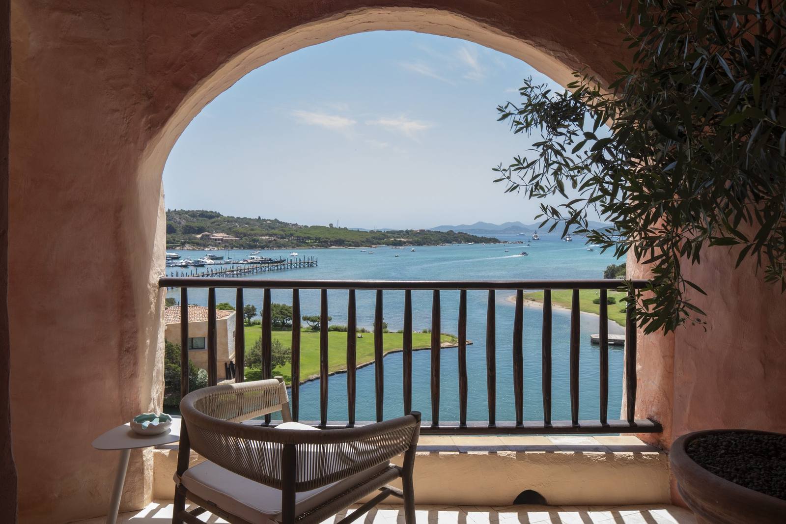 An arched terrace of the Harrods Suite framing the bay and the marina beyond