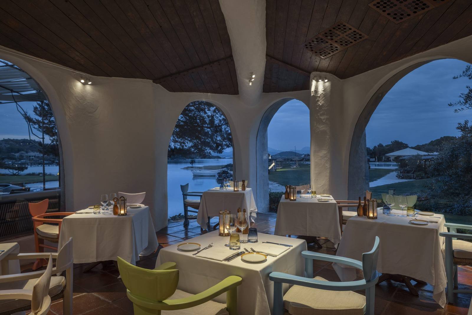 The dining room at Le Grand, with whitewashed arches opening onto the sea