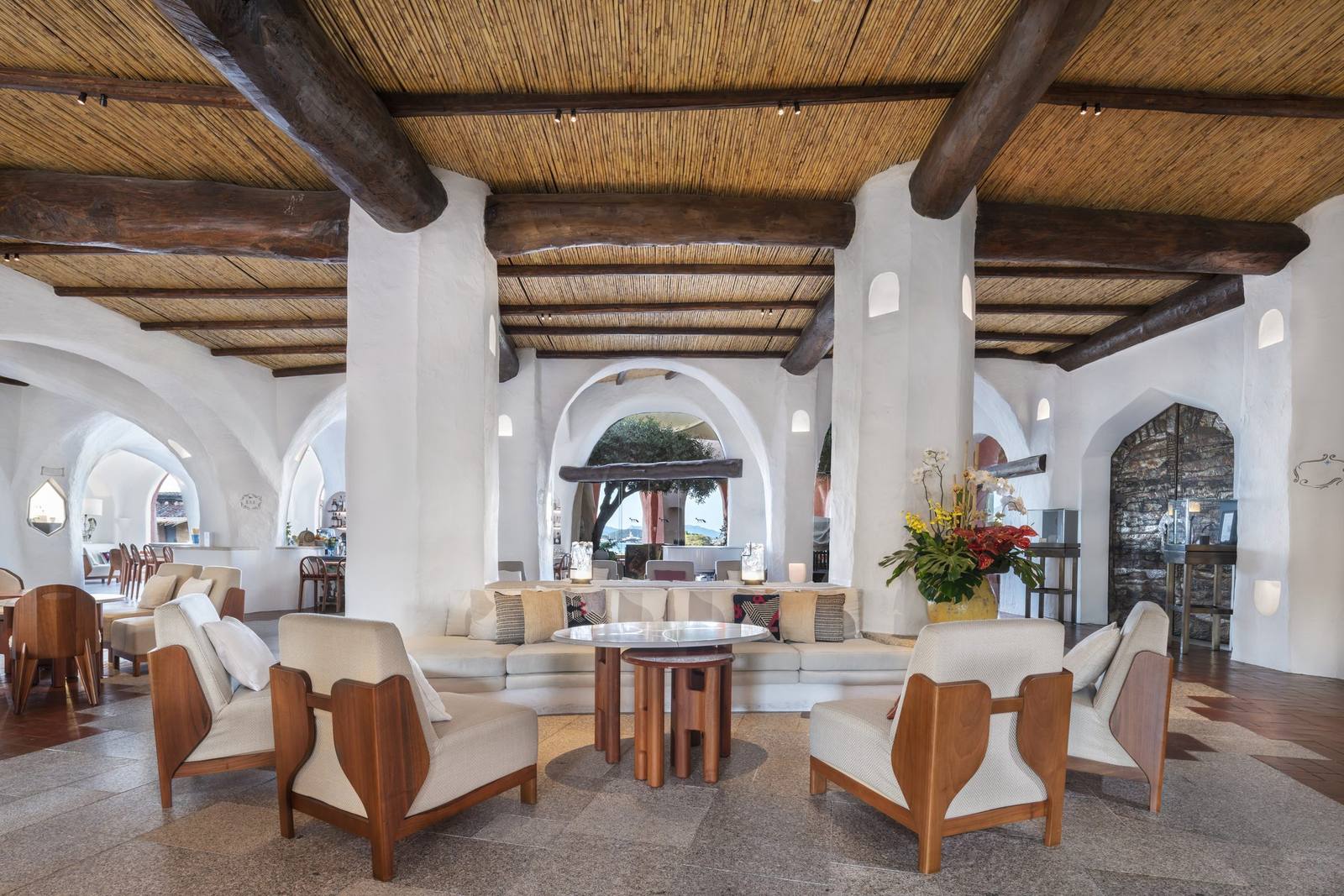 The whitewashed lobby at Cala di Volpe, with timber-beamed ceilings and arched openings