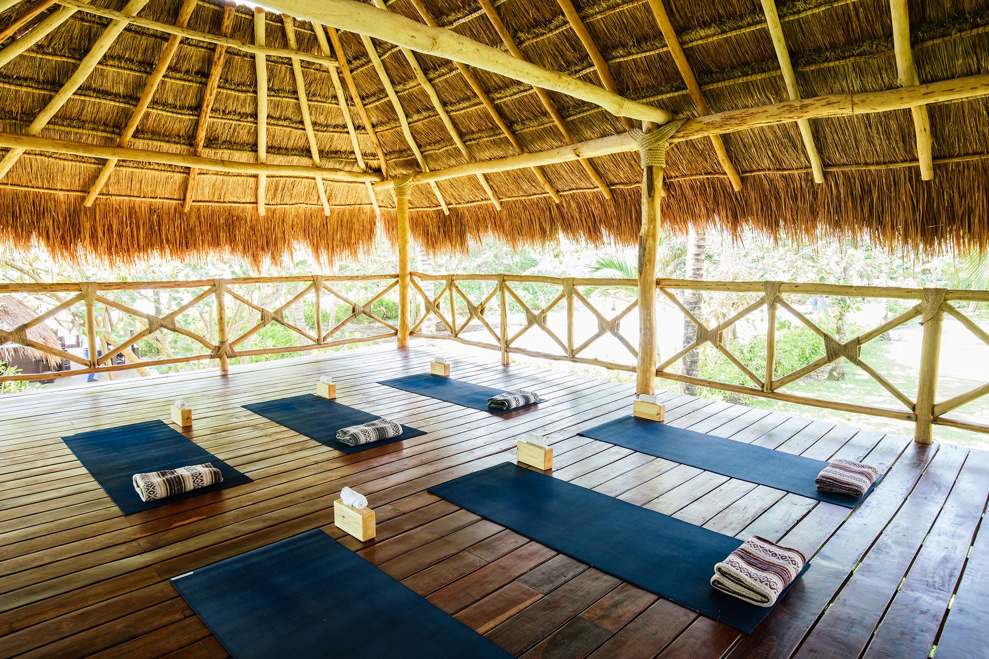 Yoga mats laid out in an open-sided palapa at Hotel Esencia