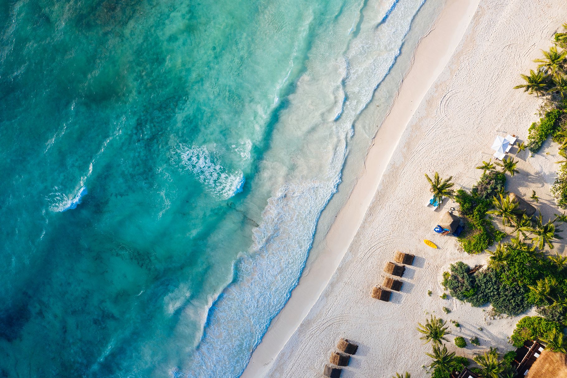 Aerial view of white sand and turquoise surf along Xpu-Ha beach at Hotel Esencia
