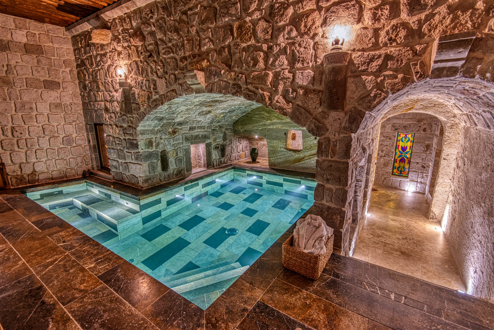 Private indoor pool under a vaulted stone cave ceiling in a suite at Museum Hotel, Cappadocia