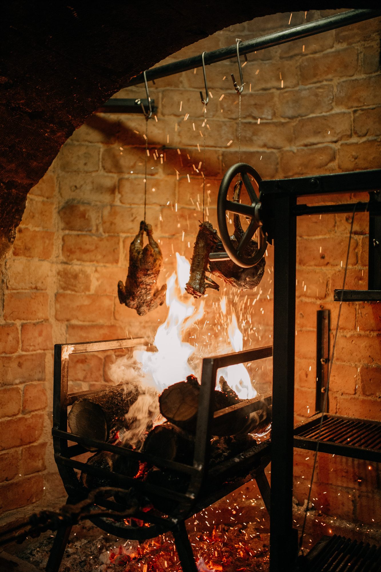 Open fire and traditional grill in the kitchen at Lil'a, Museum Hotel