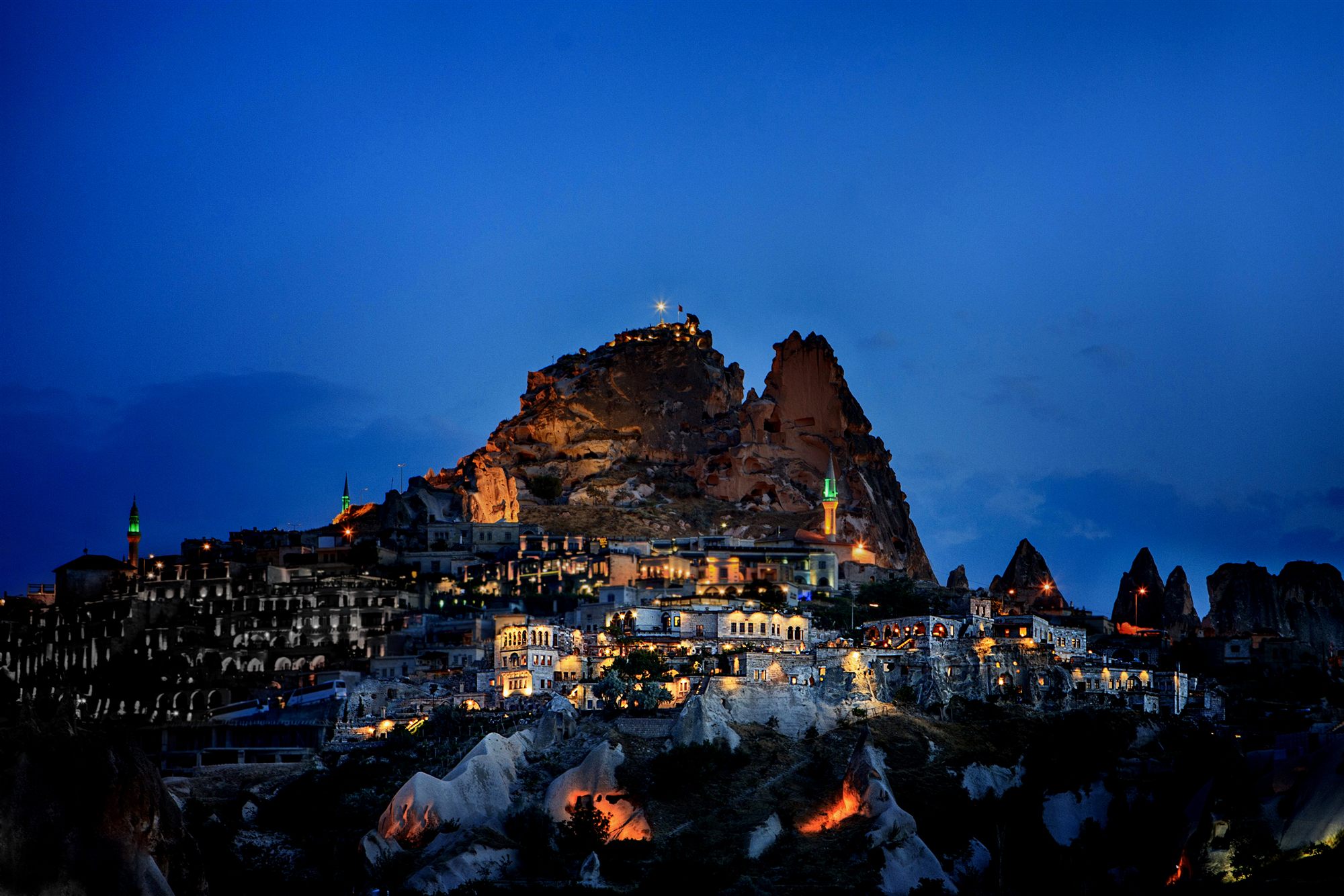 Uçhisar Castle, the rock citadel of Cappadocia, lit at night above the village