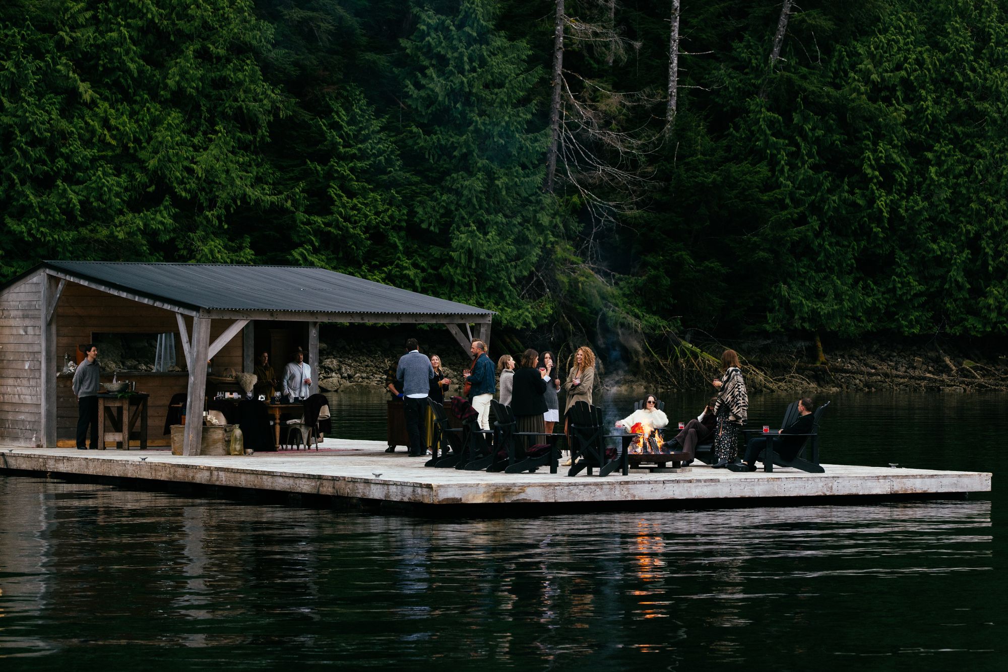 Guests dining at a floating table on the water at Nimmo Bay