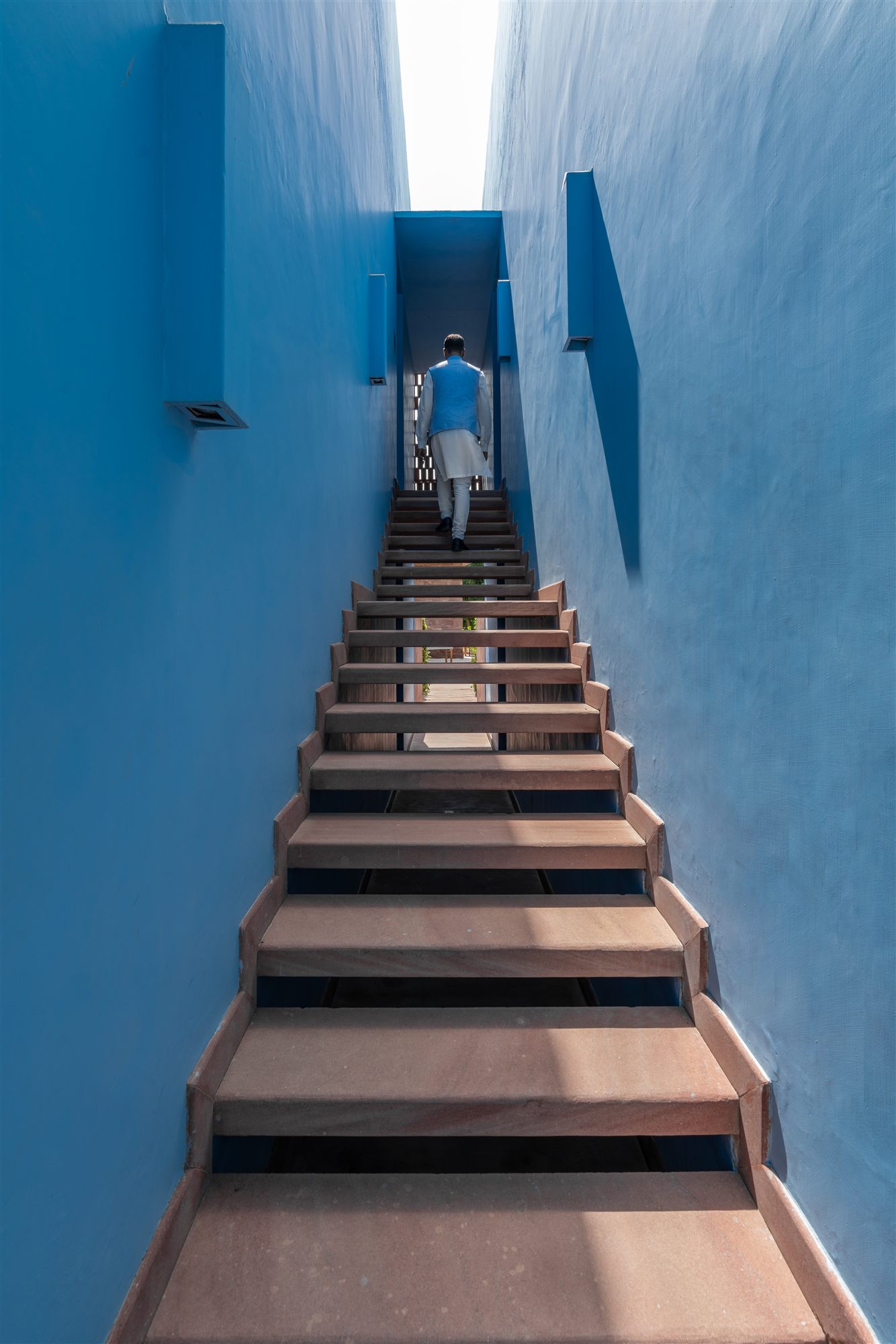 Narrow stairway between bright blue walls in Jodhpur's Blue City near RAAS Jodhpur