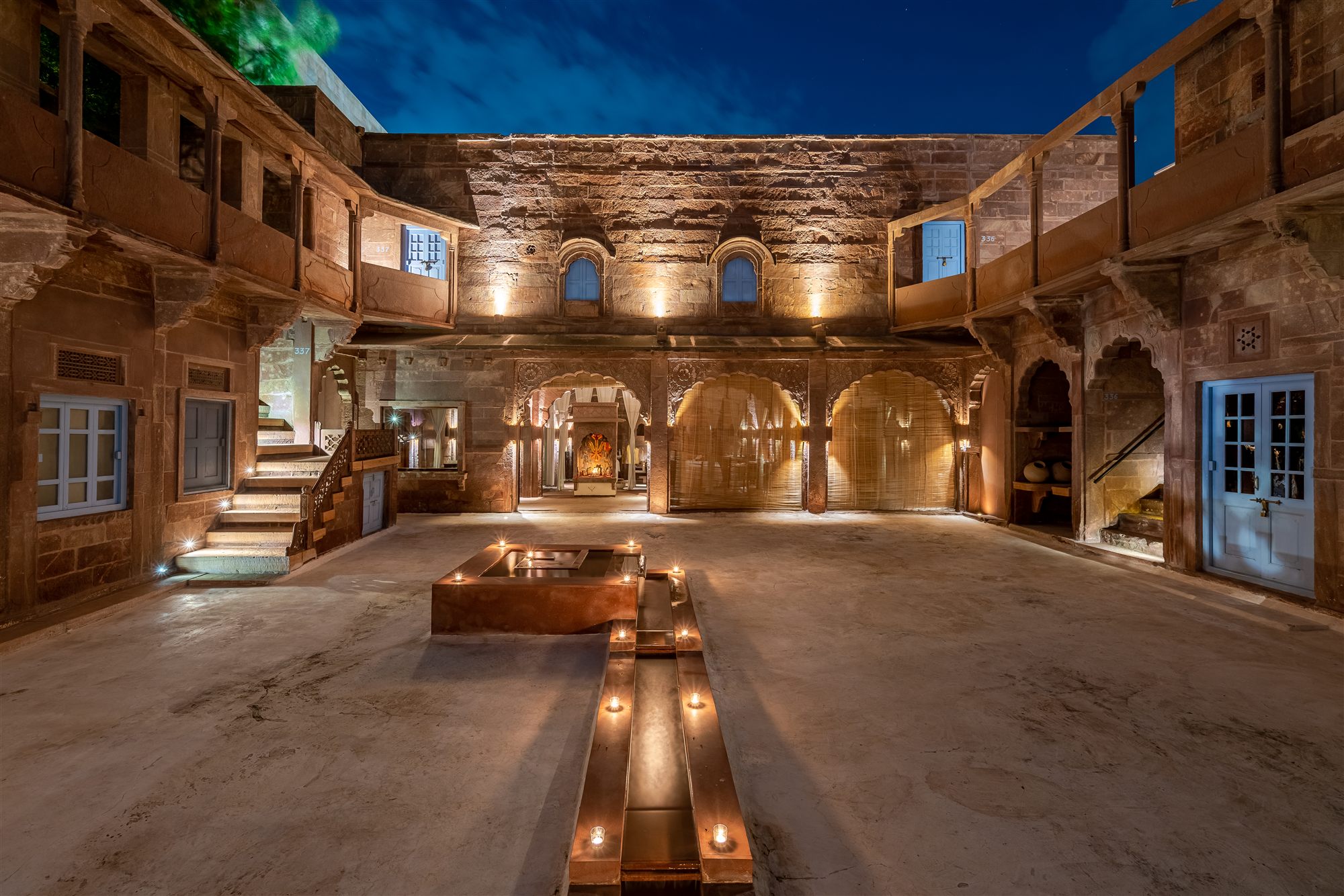 Restored 18th-century haveli courtyard at RAAS Jodhpur lit by candles at dusk