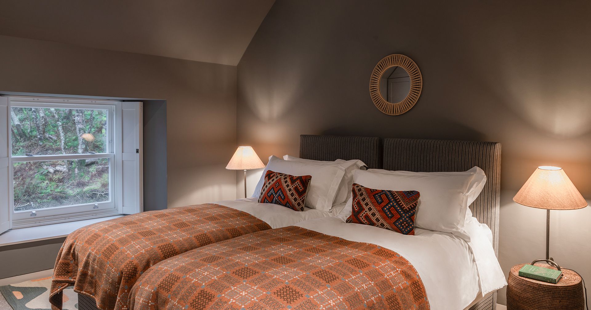 A twin bedroom at Cairnmore with tartan throws