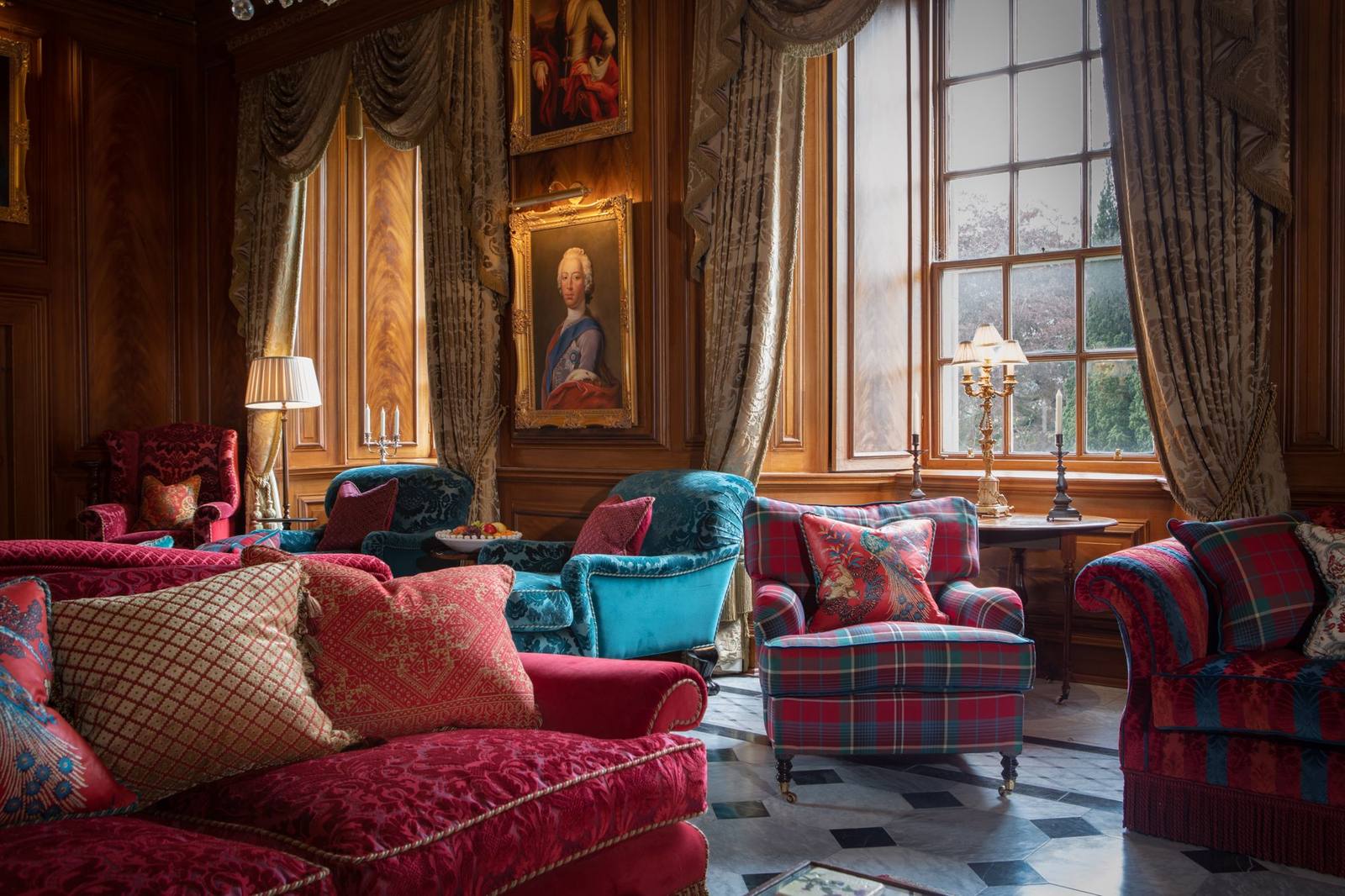 The great hall at Killochan Castle, with tartan armchairs and family portraits