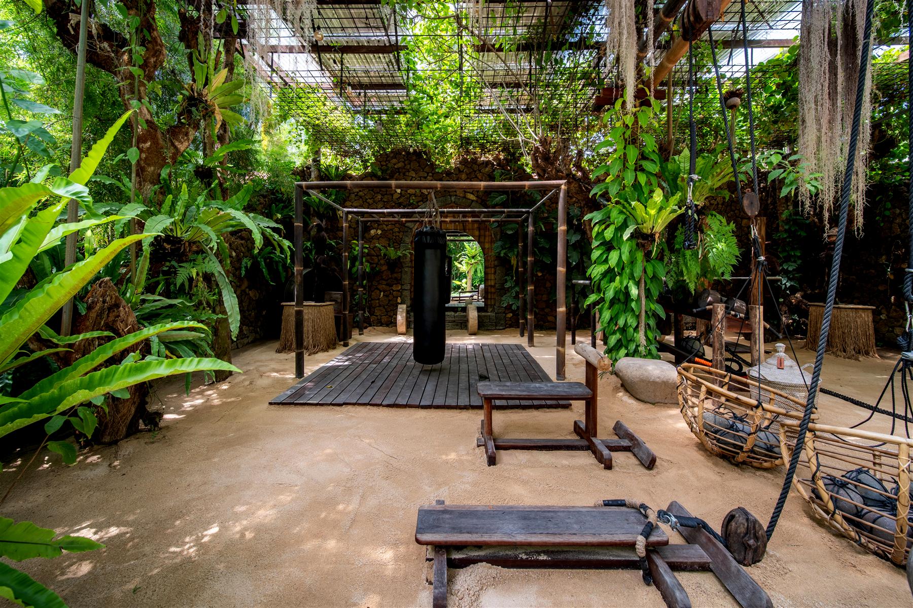 Open-air jungle gym with ropes, pulleys and hanging plants at The Seed, Candidasa, Bali