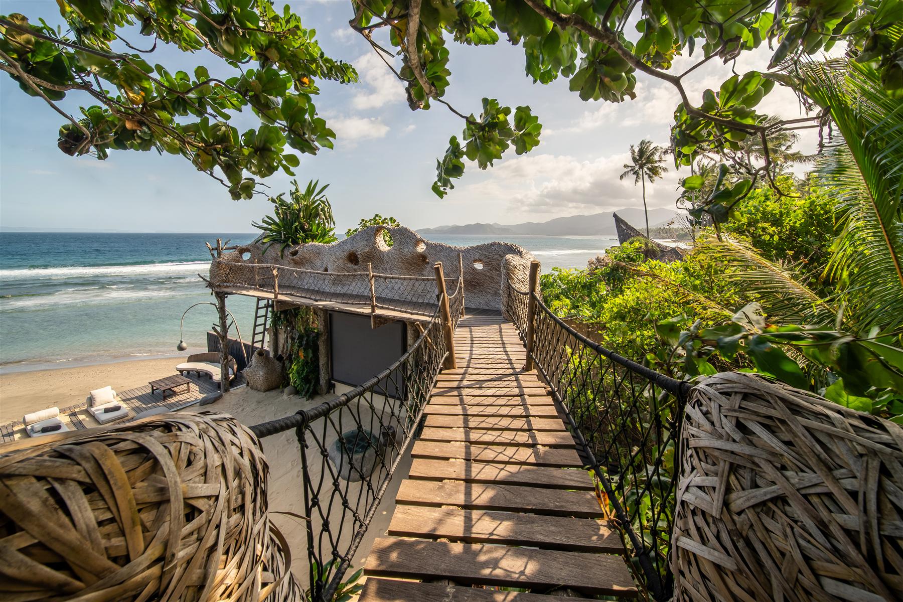 Rope bridge walkway leading to the Captain's lookout above the beach at The Seed, Bali